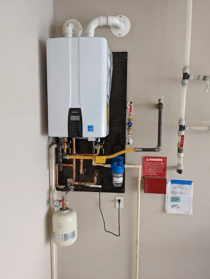 Professional plumber installing copper piping in a Eloy home